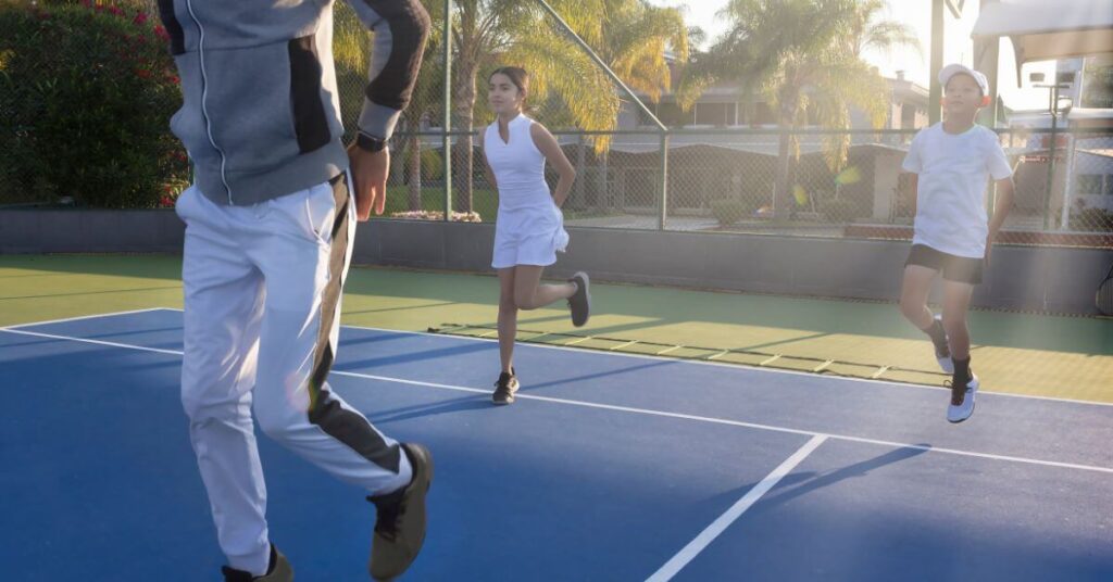 three tennis players running in place for tennis warm up exercises