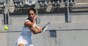 A tennis player about to show fans how to do a backhand tennis