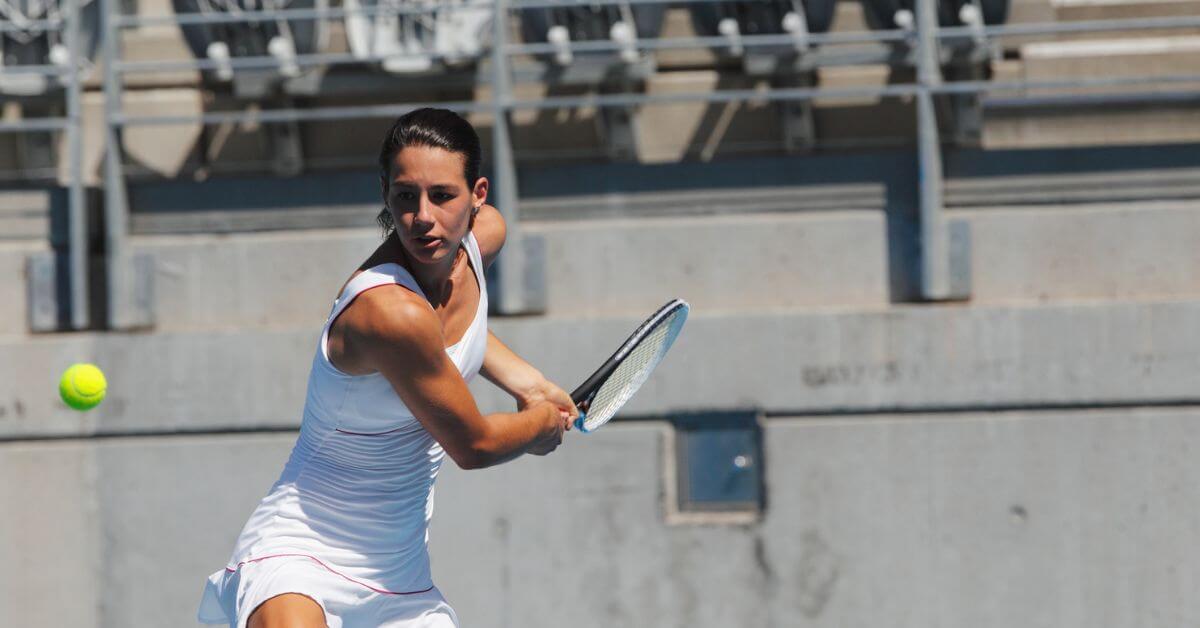 A tennis player about to show fans how to do a backhand tennis