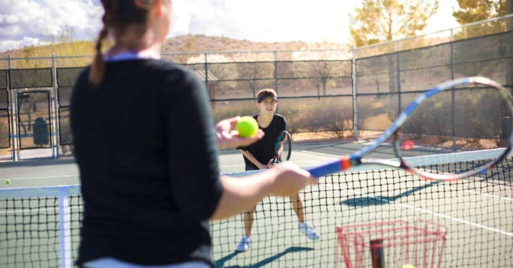 Two tennis players wearing a dark outfit
