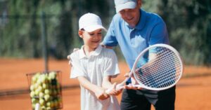 A trainer training a young tennis player showing the effects of best training apps