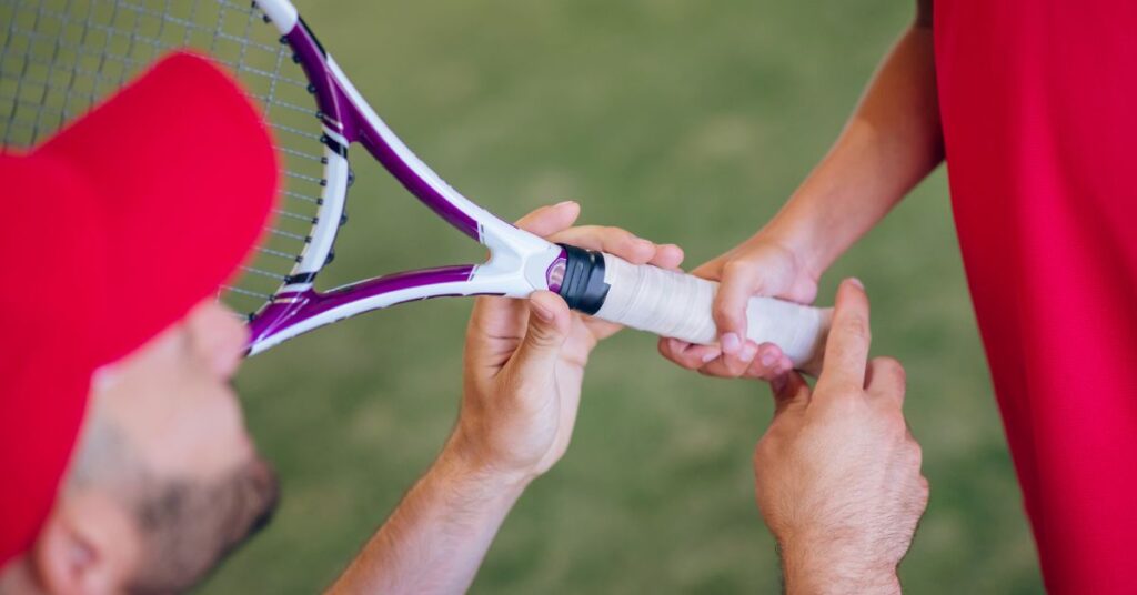 A person handing over a tennis racket to prepare for mental training for tennis