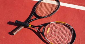 two tennis rackets on the floor showing what is soft tennis